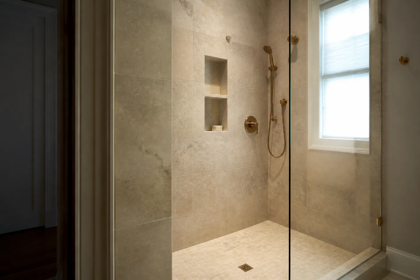 Warm stone walk-in shower with frameless glass