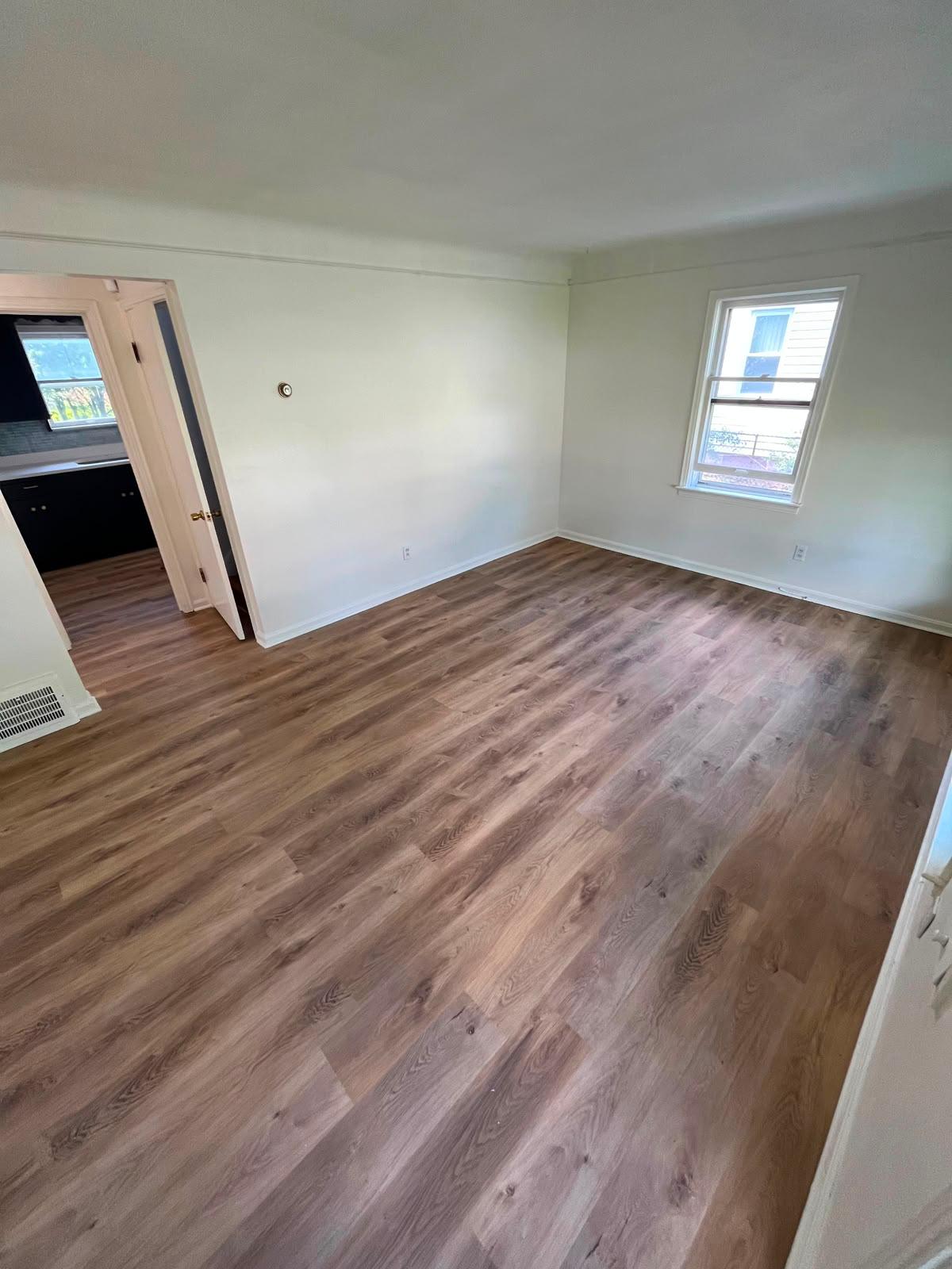 Bedroom refreshed with light walls, white trim and new plank flooring
