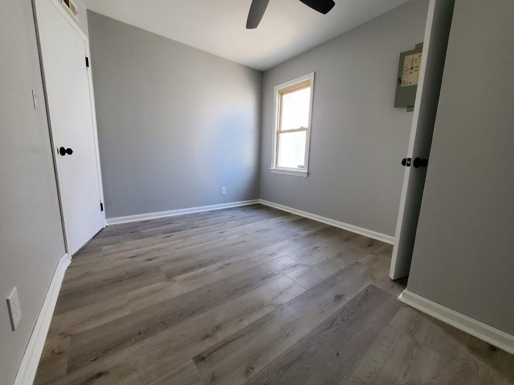Compact bedroom refreshed with gray paint, white trim and new flooring