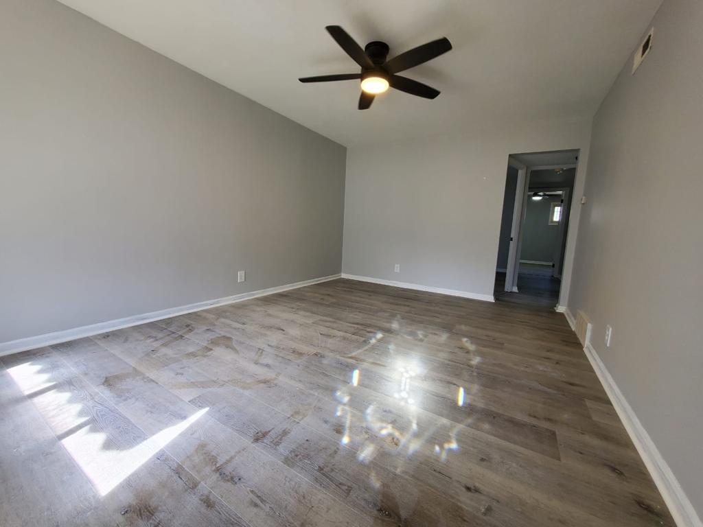 Bright finished room with gray walls and wood-look plank flooring