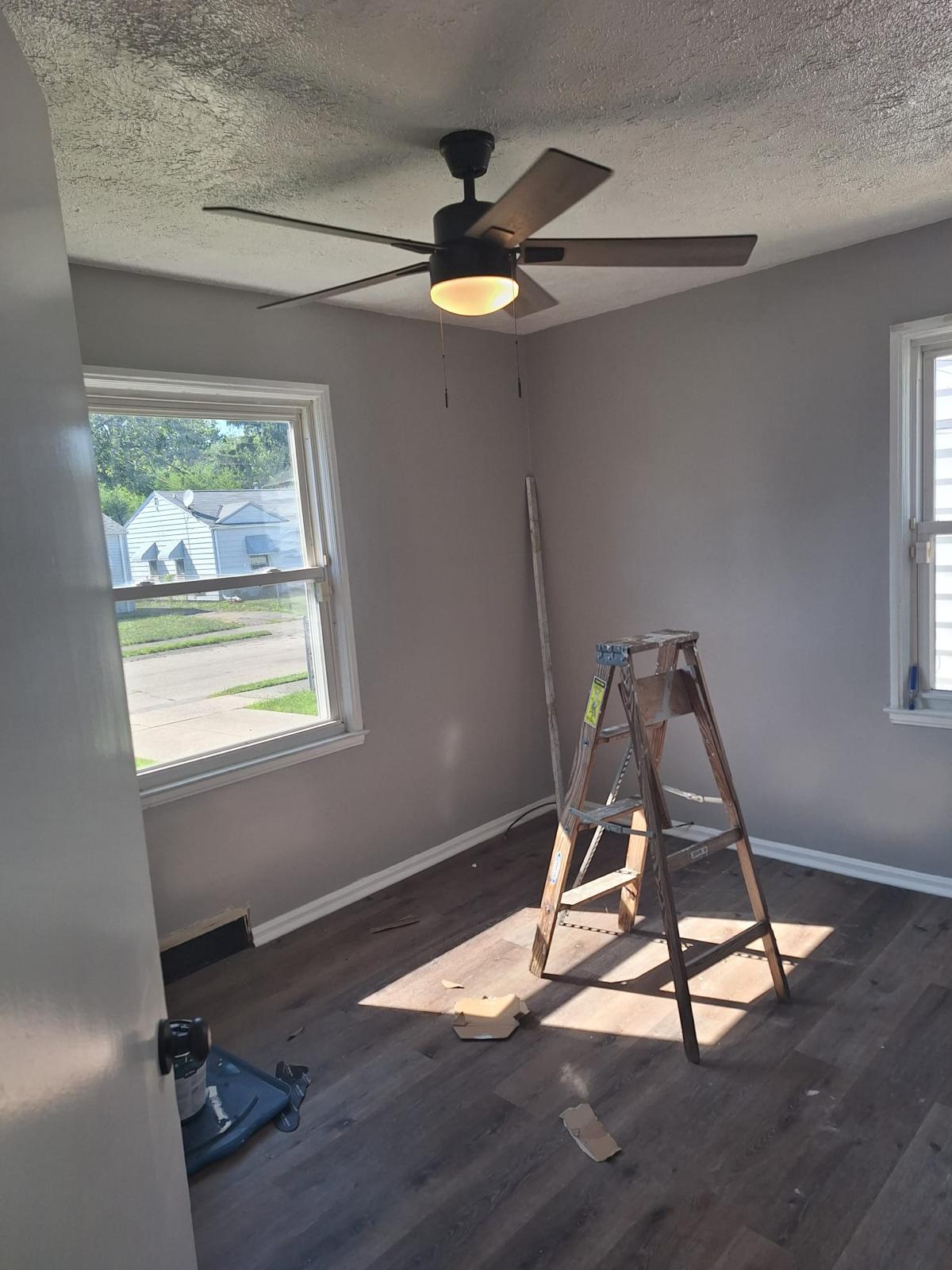 Bedroom renovation in progress with refreshed walls and new flooring