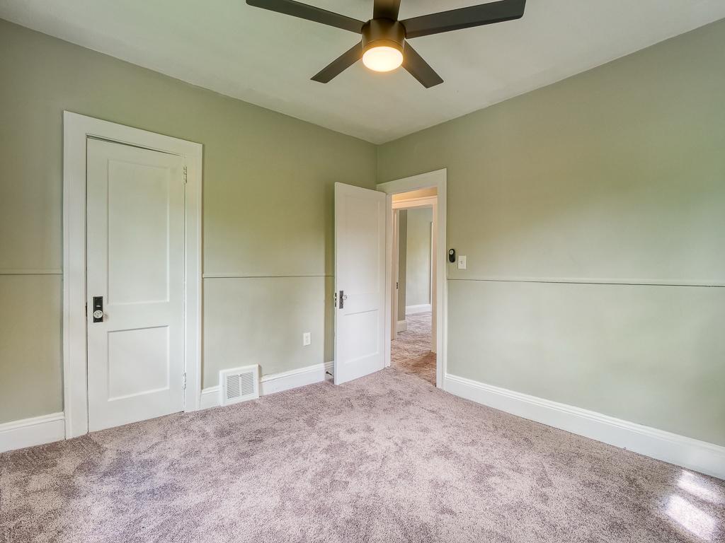 Finished bedroom with soft carpet, a ceiling fan and refreshed walls