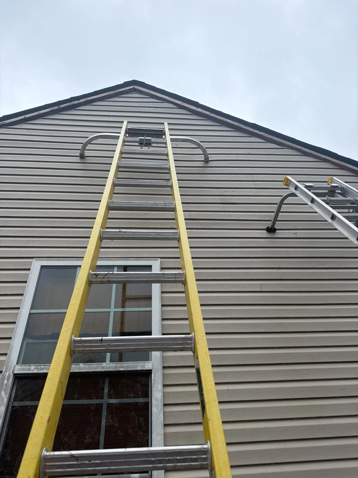 Horizontal siding on a gable wall with an extension ladder