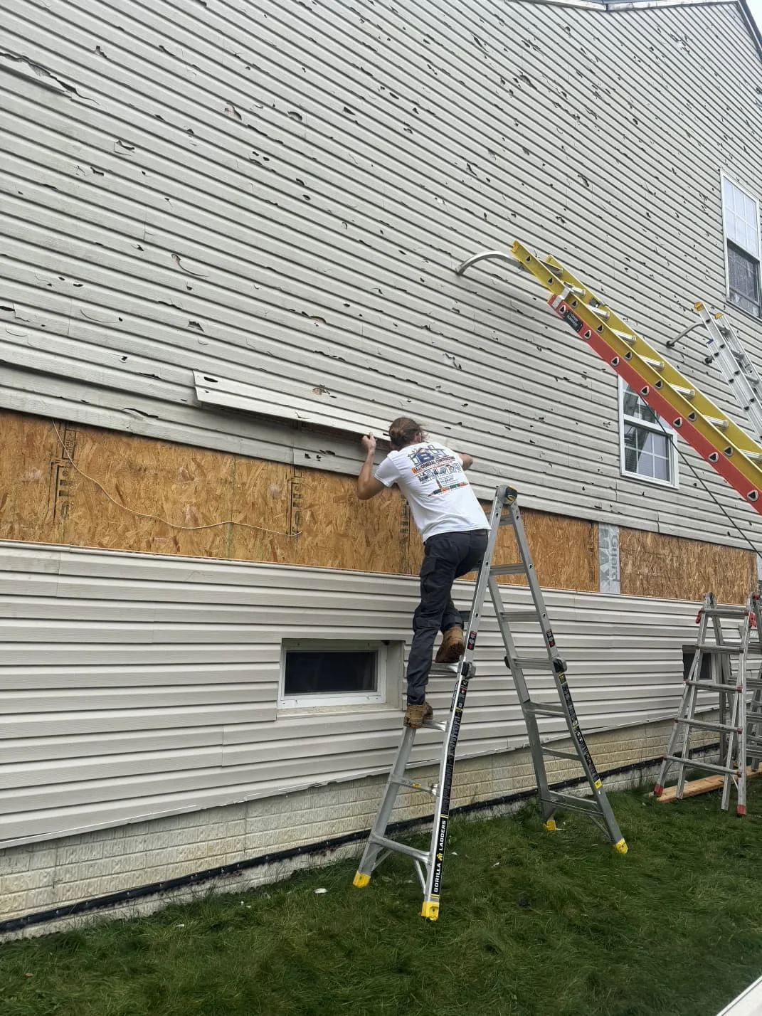 BH crew installing horizontal siding along an exterior wall