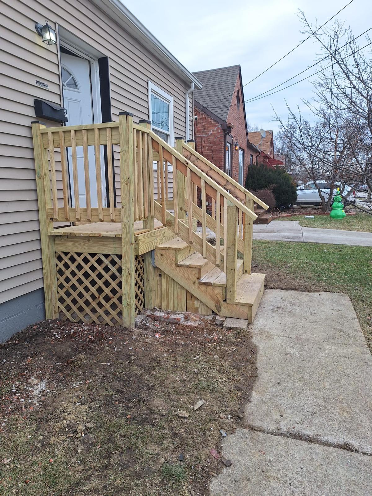 New pressure-treated wood steps installed at a rear entrance