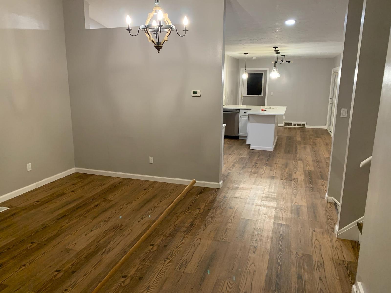 Finished open dining and kitchen area with continuous wood-look flooring
