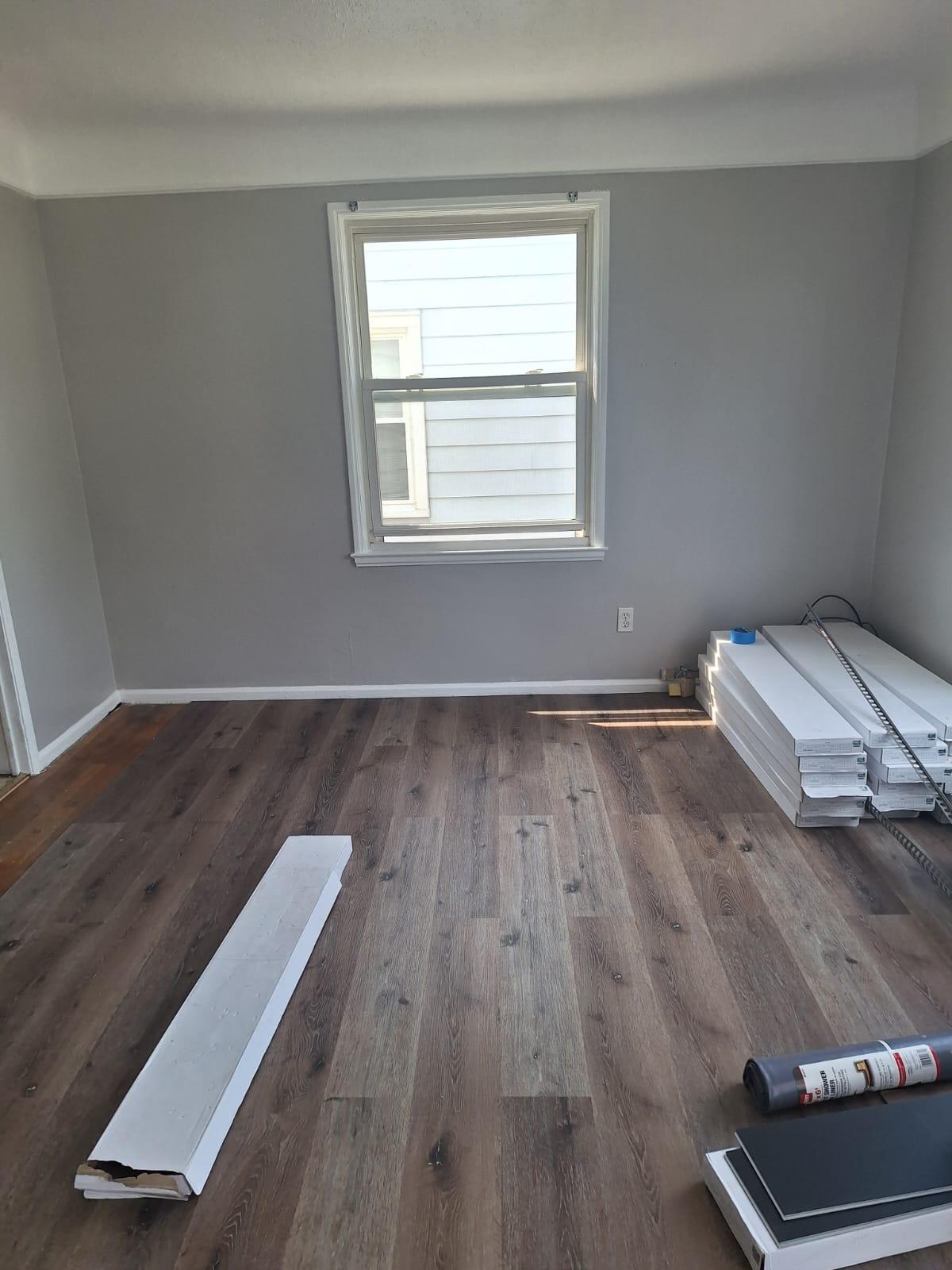 Room refreshed with gray walls, white trim and new wood-look flooring
