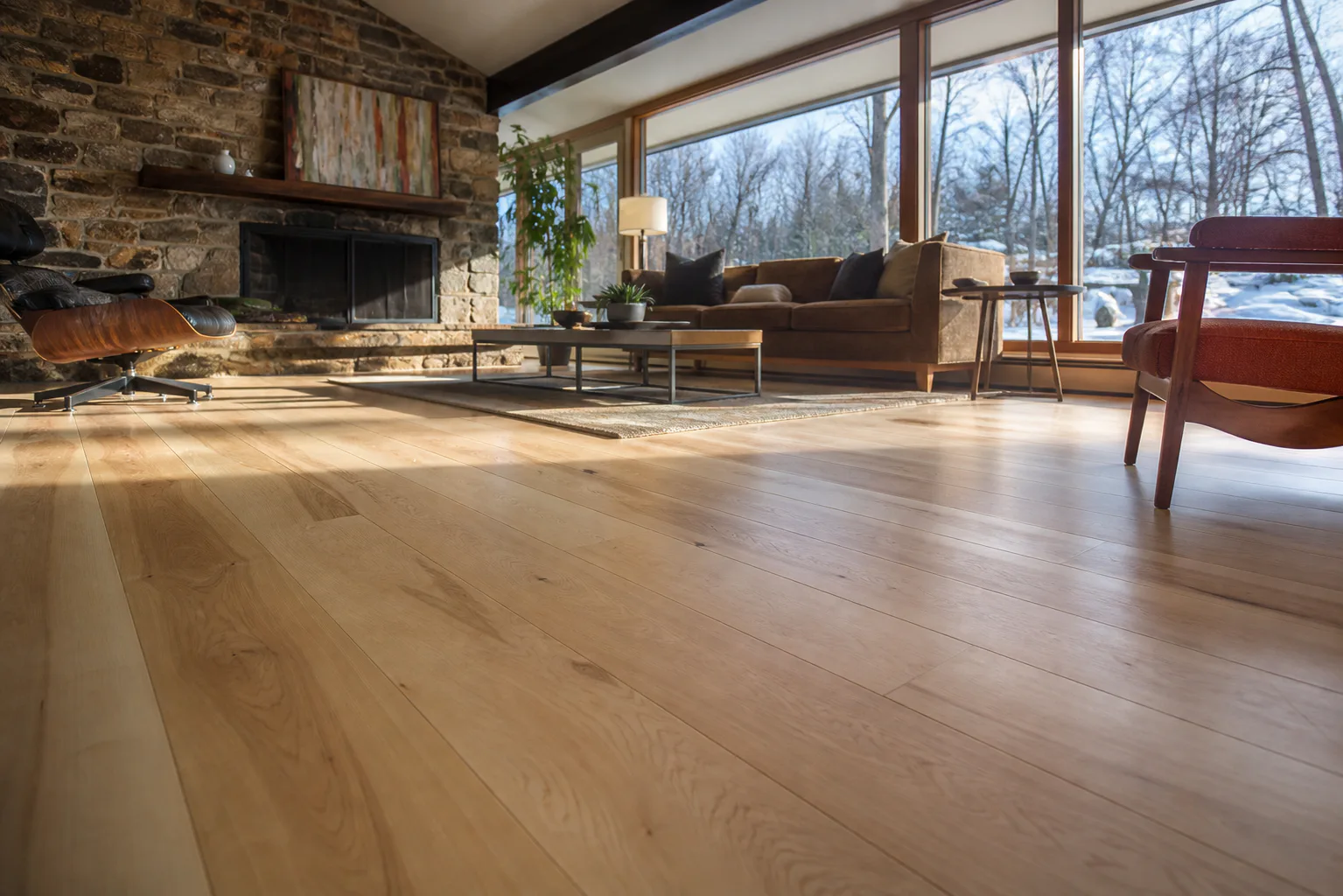 Wide-plank natural maple flooring in a mid-century great room